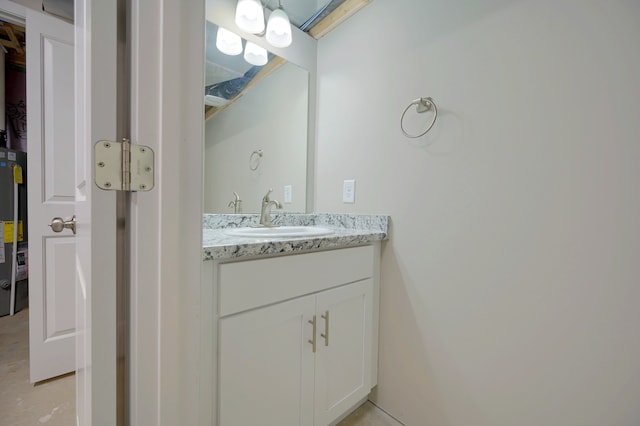 bathroom with vanity and water heater