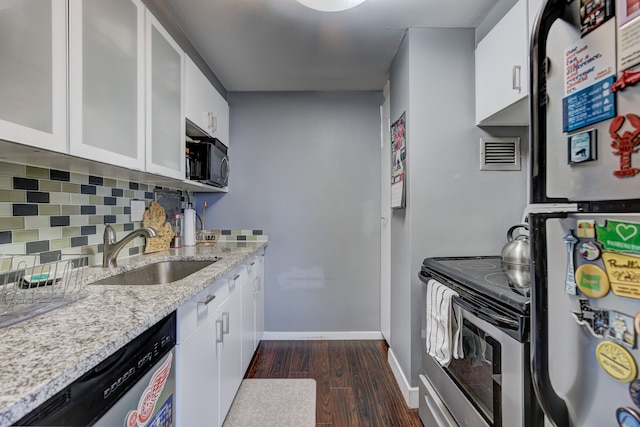 kitchen featuring white cabinetry, sink, dark hardwood / wood-style flooring, decorative backsplash, and stainless steel dishwasher