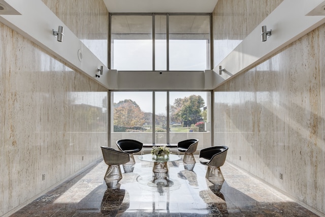 dining room featuring a towering ceiling