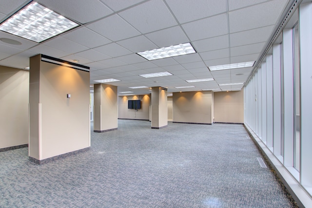 basement with a paneled ceiling