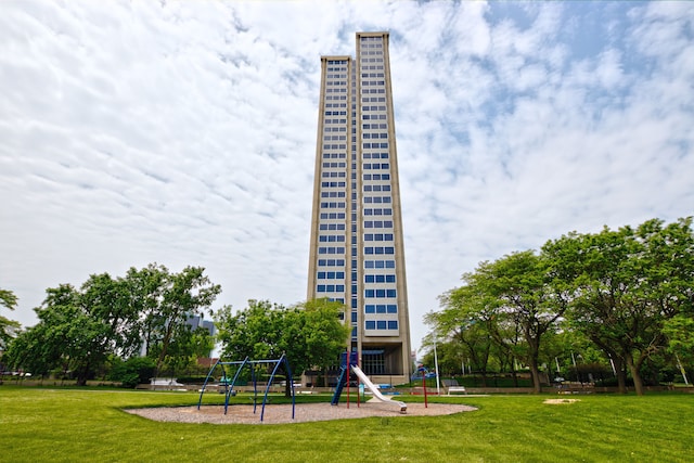 surrounding community with a playground and a lawn