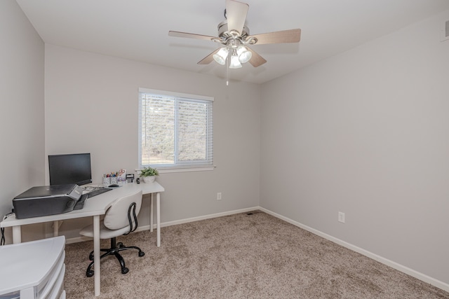 home office with light carpet and ceiling fan