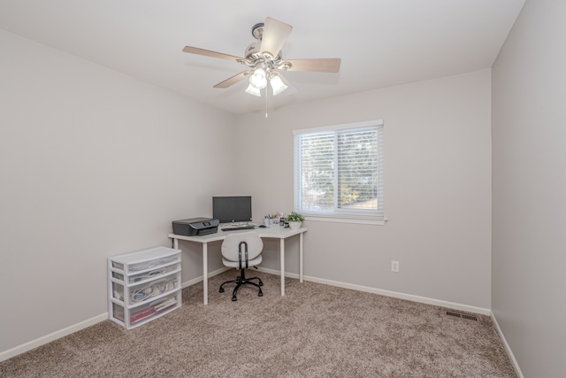 carpeted office space with ceiling fan