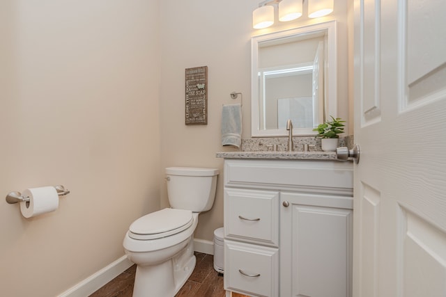 bathroom featuring vanity, toilet, and hardwood / wood-style floors