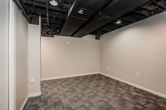 basement with dark colored carpet