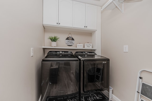 laundry area featuring independent washer and dryer and cabinets