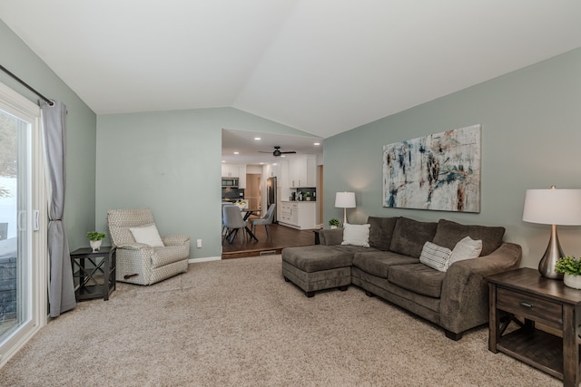 living room featuring light carpet and vaulted ceiling