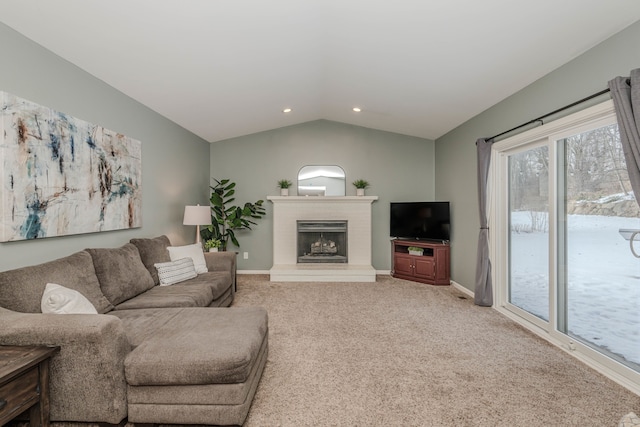 carpeted living room with vaulted ceiling and a brick fireplace