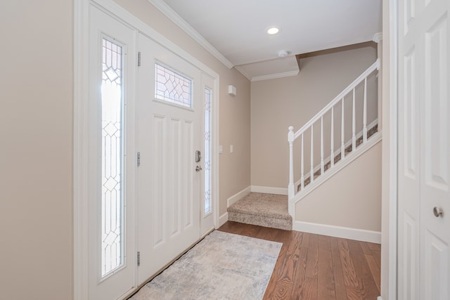 entryway with ornamental molding, hardwood / wood-style flooring, and plenty of natural light