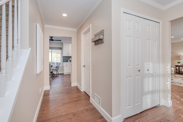 hall featuring crown molding and hardwood / wood-style floors