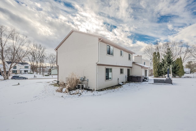 snow covered house with a hot tub