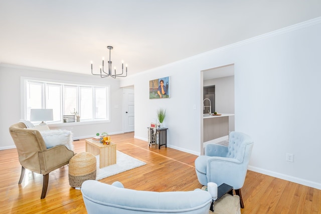 living room featuring crown molding, wood-type flooring, and a notable chandelier