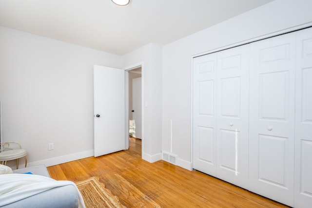 unfurnished bedroom featuring a closet and light wood-type flooring