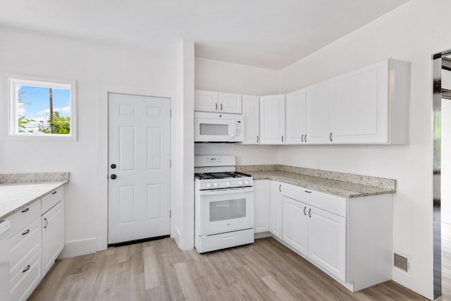 kitchen featuring white cabinetry, light stone counters, white appliances, and light hardwood / wood-style flooring