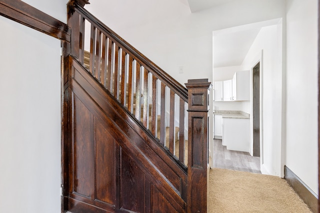 staircase with hardwood / wood-style floors