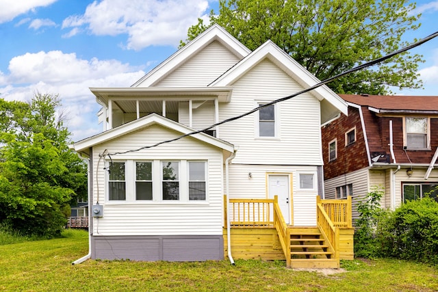 view of front of home with a wooden deck and a front lawn