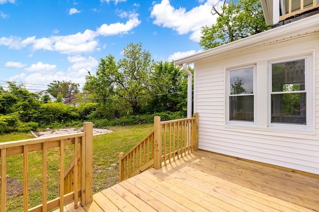 wooden terrace with a lawn