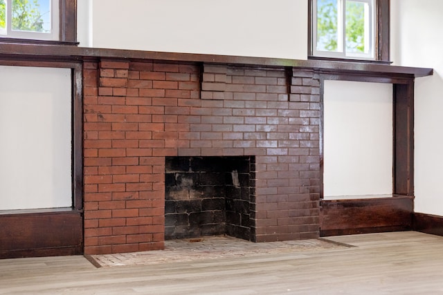 details with a brick fireplace and hardwood / wood-style floors