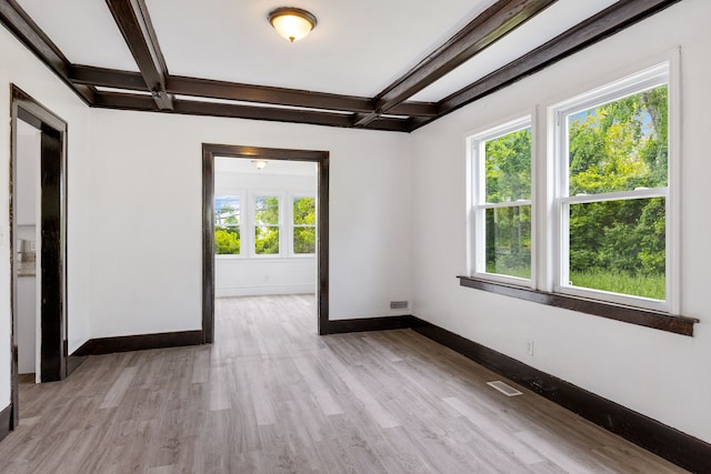 unfurnished room with coffered ceiling, light wood-type flooring, and beam ceiling