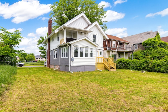 rear view of property featuring a yard