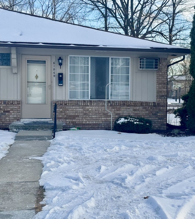 view of snow covered property entrance