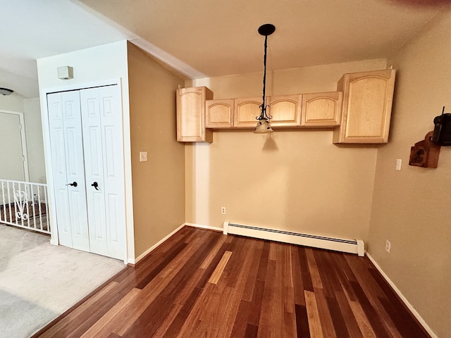 clothes washing area featuring dark wood-type flooring and a baseboard radiator