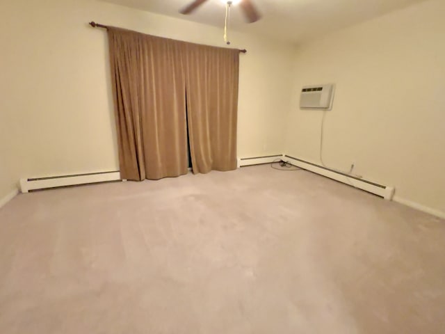 empty room featuring carpet floors, a wall unit AC, ceiling fan, and baseboard heating