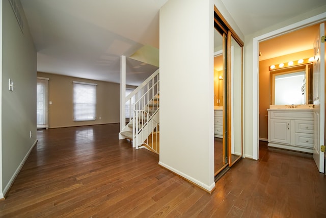 hall featuring dark hardwood / wood-style flooring and sink