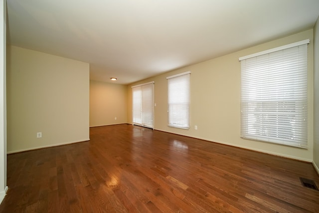 unfurnished room featuring dark wood-type flooring