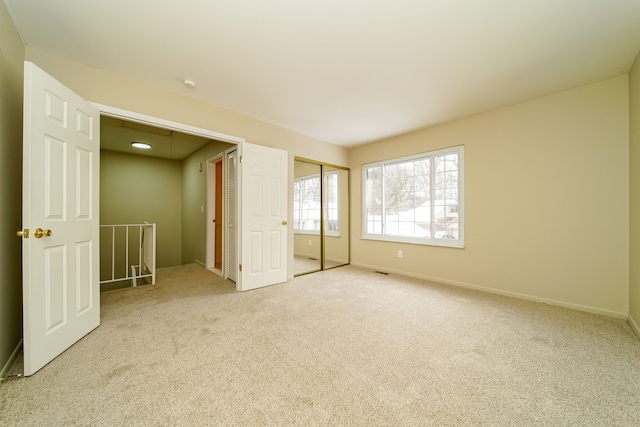 unfurnished bedroom featuring light colored carpet