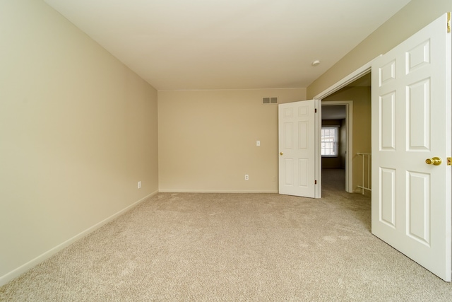 unfurnished room with light colored carpet