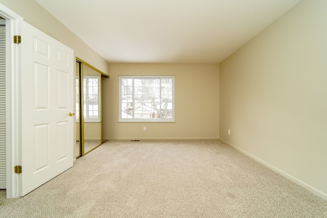 unfurnished bedroom featuring light colored carpet