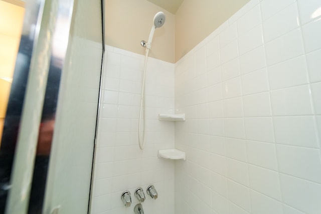 bathroom with tiled shower