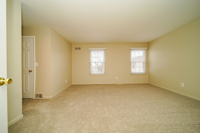 empty room featuring light colored carpet