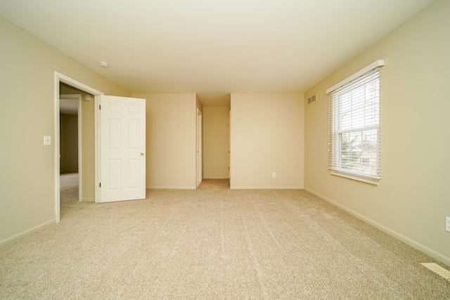 unfurnished room with light colored carpet