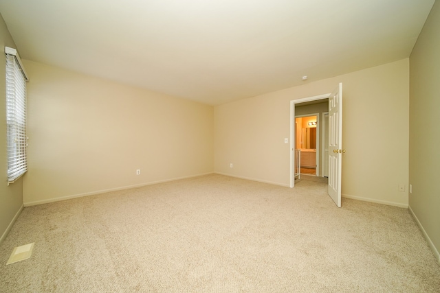 empty room featuring light colored carpet