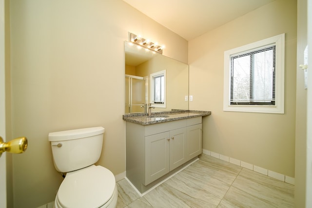 bathroom featuring vanity, tile patterned floors, and toilet