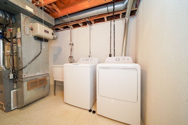 washroom with heating unit and washer and dryer