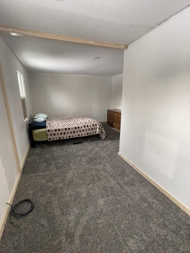 unfurnished bedroom with dark carpet