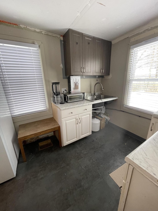 kitchen featuring crown molding and sink