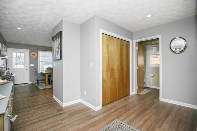 foyer featuring dark hardwood / wood-style floors and a textured ceiling