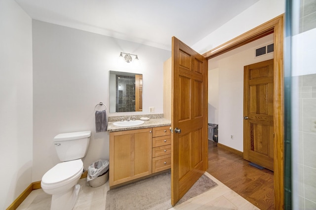 bathroom featuring hardwood / wood-style flooring, vanity, and toilet