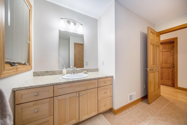 bathroom with tile patterned floors and vanity