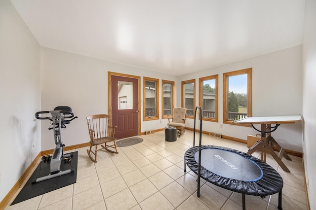 exercise room featuring light tile patterned floors