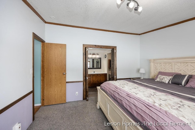 carpeted bedroom featuring ornamental molding, a textured ceiling, and ensuite bath