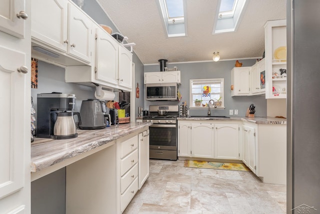 kitchen featuring white cabinetry, appliances with stainless steel finishes, sink, and a textured ceiling