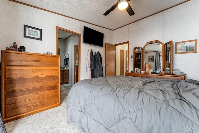 carpeted bedroom with ornamental molding, a textured ceiling, and ceiling fan