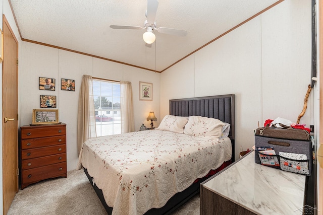 carpeted bedroom featuring ornamental molding, a textured ceiling, and ceiling fan