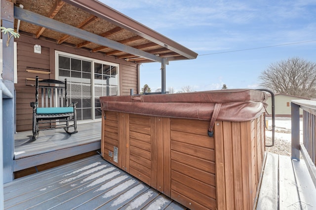 wooden deck with a hot tub