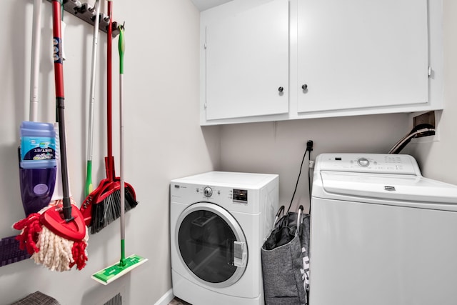 washroom featuring cabinets and independent washer and dryer